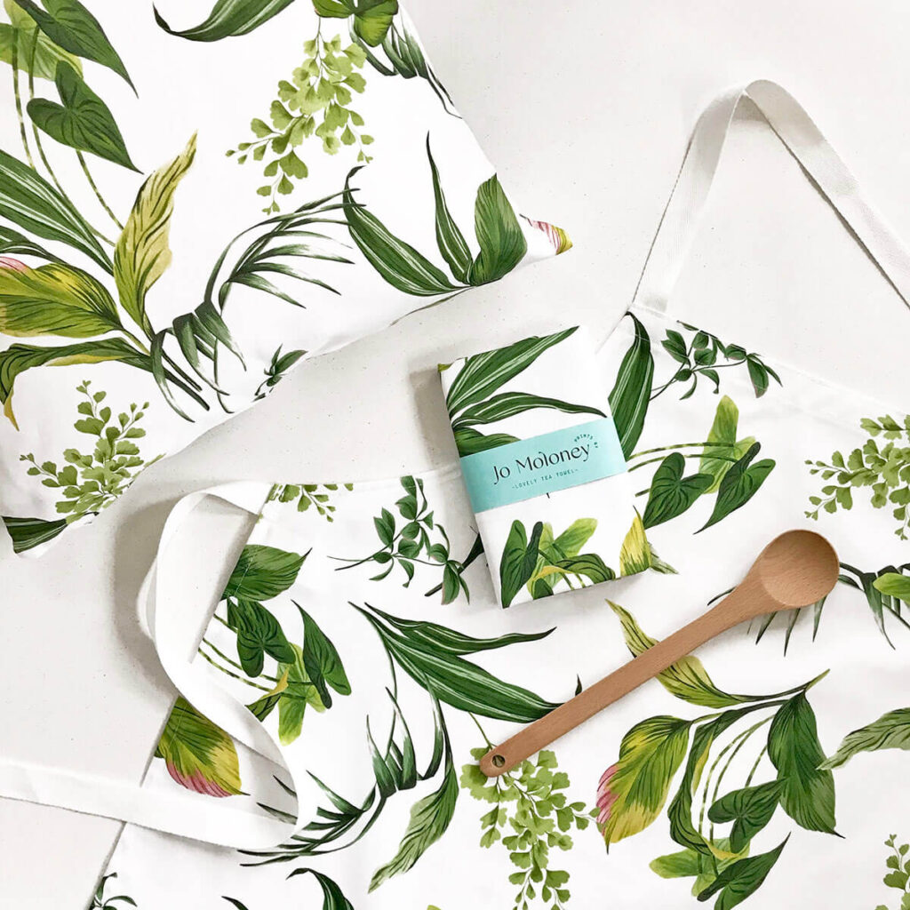 Apron, tea towel and cushion in a beautiful leaf print. House plant print bring the inside into your home