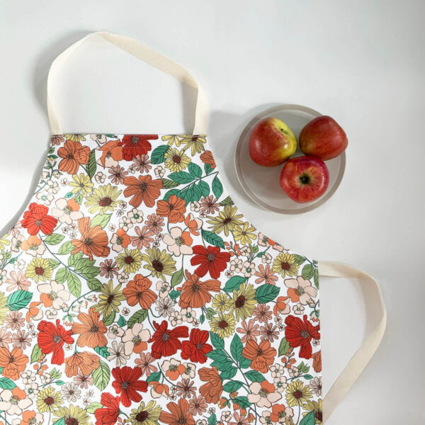Peach Floral Apron with bowl of apples