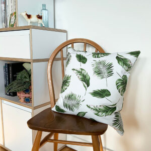 Tropical leaf cushion cover on a wooden chair
